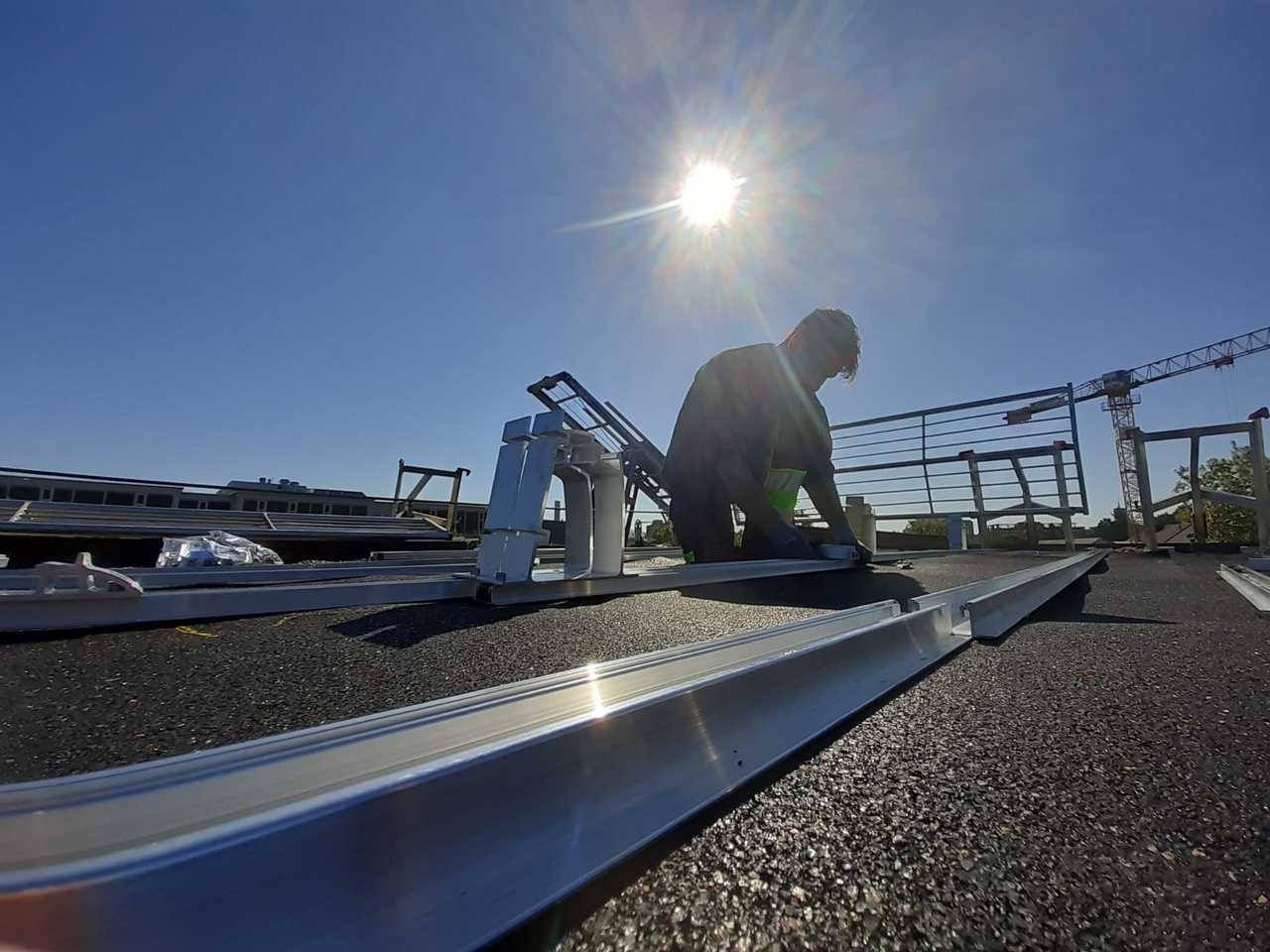 Ein Mann bereitet auf dem Dach die Installation einer Solaranlage vor