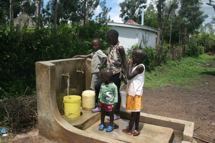 Kinder holen aus dem Brunnen frisches Wasser. Ermöglicht wird dies durch den Solar-Wasser-Kiosk.